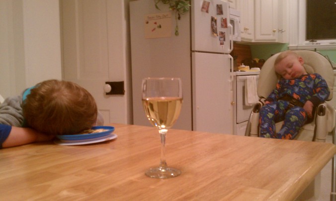 Boys asleep wine on table