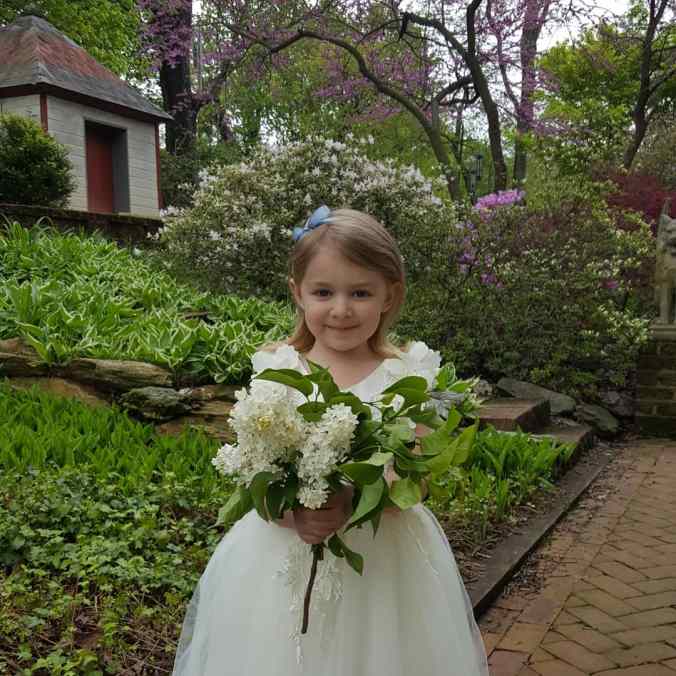 The author's daughter in a flower girl dress